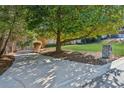 Long driveway leading to a stately home, accented by a stone mailbox and shaded by mature trees at 3611 Howell Wood Trl, Duluth, GA 30096