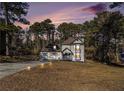 Two-story house exterior at dusk with a two-car garage at 6492 Swift Creek Rd, Lithonia, GA 30058