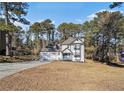 Two-story white house with a two-car garage and yard at 6492 Swift Creek Rd, Lithonia, GA 30058