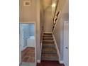 Staircase with carpeted steps and wooden handrail at 658 Austin Creek Dr, Buford, GA 30518