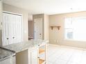 Eat-in kitchen with granite countertops and white cabinets at 12384 Riviera Dr, Fayetteville, GA 30215