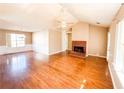 Spacious living room featuring hardwood floors and a brick fireplace at 12384 Riviera Dr, Fayetteville, GA 30215