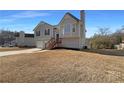 Gray siding two-story house with attached garage and landscaping at 225 Winchester Dr, Villa Rica, GA 30180