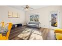 Open living area with gray sofa, wood-look floors, and access to a patio at 2570 Bayrose Cir, Atlanta, GA 30344