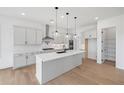 Modern kitchen with white cabinets, quartz countertops, and island at 6315 Wallace Farms Dr, Cumming, GA 30028