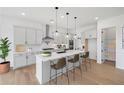 Modern kitchen with white cabinets, quartz countertops, and island at 6315 Wallace Farms Dr, Cumming, GA 30028