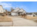 House with driveway and landscaping at 303 Breezy Hill Walk, Stockbridge, GA 30281
