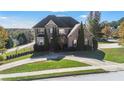 Charming two-story brick home featuring mature landscaping and a welcoming front entrance at 4851 Planters Walk, Douglasville, GA 30135