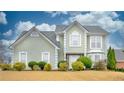 Beautiful two-story house with light green vinyl siding and manicured lawn at 729 River Bridge Dr, Lawrenceville, GA 30046