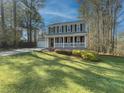 Two-story house on a grassy lot with a large front yard and a white porch at 601 Ashton Ln, Lawrenceville, GA 30044