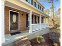 Home features a dark brown front door, brick accents and a white porch at 601 Ashton Ln, Lawrenceville, GA 30044