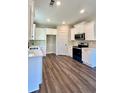 Modern kitchen with white cabinets and stainless steel appliances at 111 Cassville-White, Cartersville, GA 30121