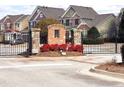 Gated community entrance with brick pillars and lush landscaping at 2429 Sardis Chase Ct, Buford, GA 30519