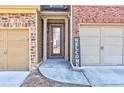 Townhome entry with glass door and welcoming sign at 2429 Sardis Chase Ct, Buford, GA 30519