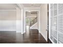 Bright and spacious entryway with dark hardwood floors and staircase at 3737 Lockaby Way, Lawrenceville, GA 30044