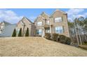 Brick home with a large front yard and mature trees at 420 Silver Brook Dr, Woodstock, GA 30188