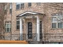 Townhome exterior featuring brick facade and a covered entryway at 4223 Deming Cir, Atlanta, GA 30342