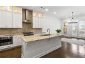 Modern kitchen with white cabinets, granite island, and stainless steel appliances at 4223 Deming Cir, Atlanta, GA 30342