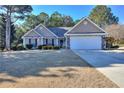 Inviting single-story home with stone accents, a well-kept lawn, and an attached garage at 340 Annslee Cir, Loganville, GA 30052