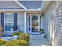 Glass front door with sidelights and a chair at 340 Annslee Cir, Loganville, GA 30052