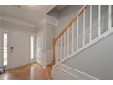 Bright entry with hardwood floors, staircase, and neutral paint at 5146 Manerdale Se Dr # 4, Atlanta, GA 30339