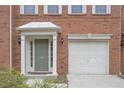 Green front door, white garage door, and brick facade at 5146 Manerdale Se Dr # 4, Atlanta, GA 30339