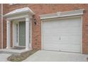 White garage door with brick exterior at 5146 Manerdale Se Dr # 4, Atlanta, GA 30339