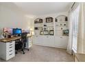 Home office with built-in shelving, large desk, and dual monitors at 5220 Otter Creek Run, Cumming, GA 30040