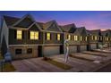 Townhomes at night showcasing the lighting and architectural details at 11555 Chatham Dr, Hampton, GA 30228