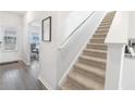 Modern interior staircase with carpet runner and wood flooring in the entryway at 11559 Chatham Dr, Hampton, GA 30228