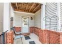 Brick front porch with two chairs and a wreath on the front door at 593 Shadow Valley Ct, Lithonia, GA 30058