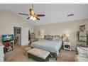 Spacious main bedroom with king-size bed, ceiling fan, and ample natural light at 593 Shadow Valley Ct, Lithonia, GA 30058