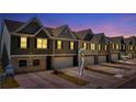Attractive townhomes at night, showcasing modern design and landscaping at 11571 Chatham Dr, Hampton, GA 30228