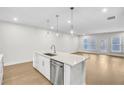 Modern kitchen island with white cabinets and stainless steel dishwasher at 134 Briargate Dr # 16, Johns Creek, GA 30097