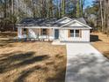 Single-story house with gray roof and white siding, driveway, and yard at 2716 Battle Sw Trl, Marietta, GA 30064