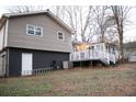 House with a deck overlooking a wooded backyard at 115 S Meadowcliff Cir, Carrollton, GA 30116