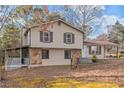 Beige two-story house with stone accents and covered porch at 2491 Crumps Landing Circle, Snellville, GA 30039