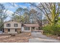 Two-story house with carport and mature trees surrounding at 2491 Crumps Landing Cir, Snellville, GA 30039