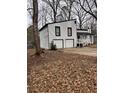 Two-car garage and deck on a white house with black trim at 702 Talemwood Ct, Lawrenceville, GA 30044