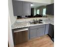 Modern kitchen featuring gray cabinets and granite countertops at 894 Glynn Oaks Dr, Clarkston, GA 30021