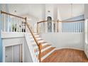 Elegant staircase with wooden steps, white risers and railings, leading to a bright and airy second floor at 1379 Paddocks Way, Powder Springs, GA 30127