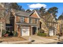 Charming two-story home with brick accents, manicured lawn, and attached one car garage at 1538 Park Grove Dr, Lawrenceville, GA 30046