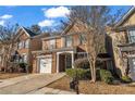 Charming two-story home with brick accents, manicured lawn, and attached one car garage at 1538 Park Grove Dr, Lawrenceville, GA 30046