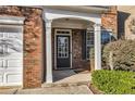 Close up of front door with brick facade and white pillars at entrance at 1538 Park Grove Dr, Lawrenceville, GA 30046