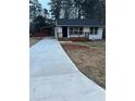 Newly renovated home with a long driveway and modern deck at 1840 Judy Se Cir, Marietta, GA 30060