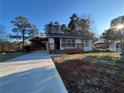 Modern white house with a wooden deck and carport at 1840 Judy Se Cir, Marietta, GA 30060