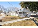 Side view of a charming white cottage with a large yard at 3170 New Macland Rd, Powder Springs, GA 30127