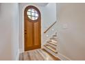 Light-filled entryway with hardwood floors and a beautiful wooden door at 2179 William Way, Atlanta, GA 30345