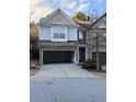 Two-story townhome with a two-car garage and landscaping at 3144 Spicy Cedar Ln, Lithonia, GA 30038
