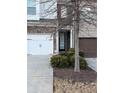 Townhome entrance with a stone facade and landscaping at 3144 Spicy Cedar Ln, Lithonia, GA 30038